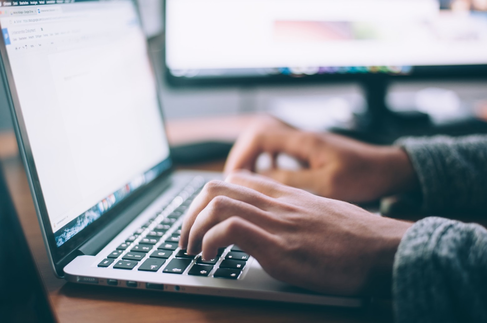 Person typing on a keyboard