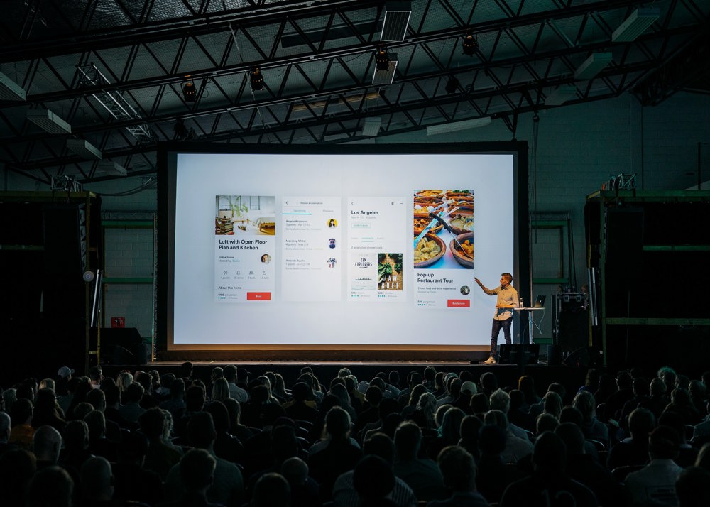 Presenter on stage at a conference