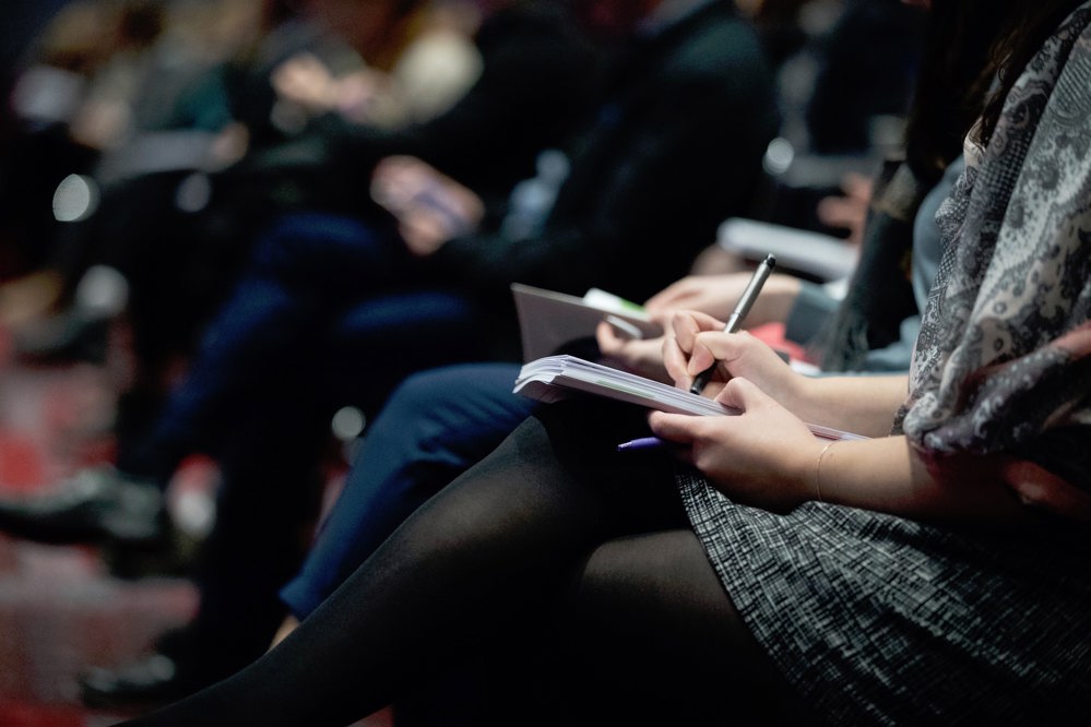 Conference participants taking notes