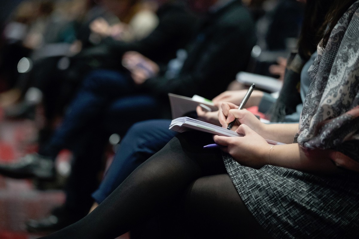 Conference attendee taking notes